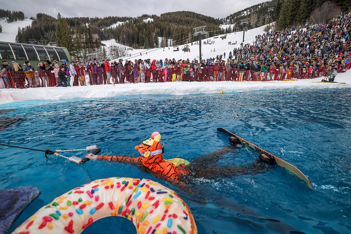 A competitor is pulled out of the pool by resort workers on Saturday. (JP Edge photo)