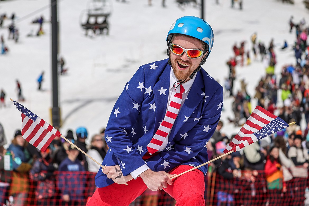 A competitor celebrates a successful pond skim attempt on Saturday. (JP Edge photo)