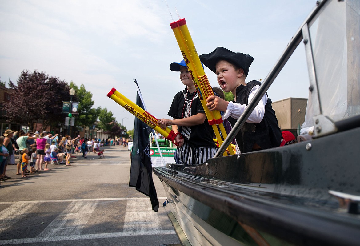 River Magner and Nate Anderson spray water on the crowd from their family float, Graybeard Pirates, at the Saint Stanislaus Saints Parade to celebrate Rathdrum Days in 2016.