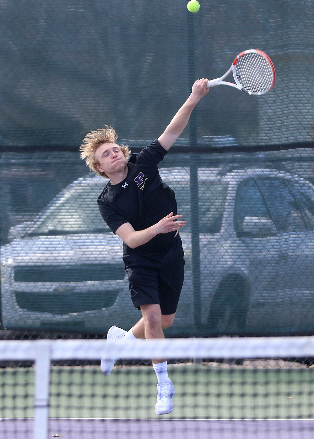 Colter Wilson flies high during doubles competition against Dillon Saturday. (Bob Gunderson photo)