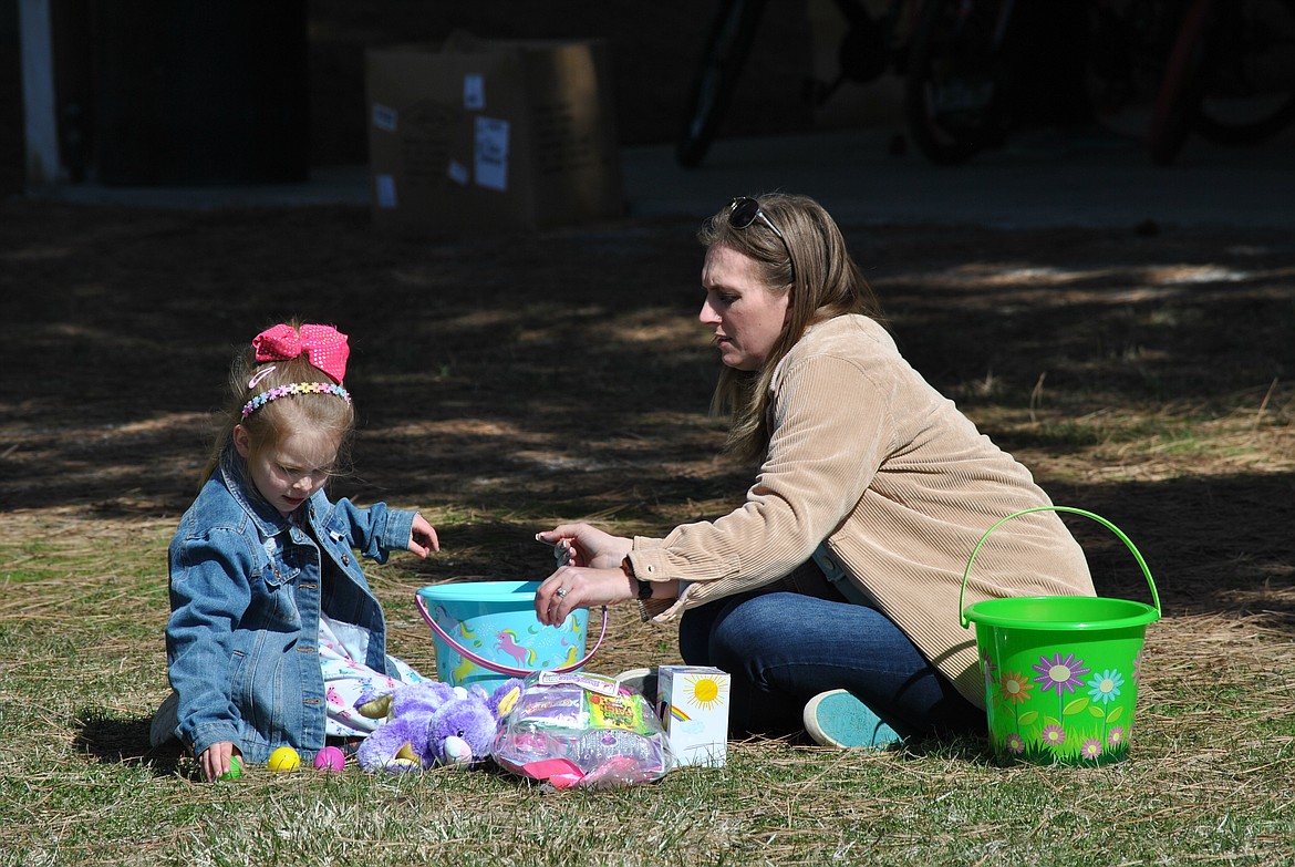 A mom and daughter sort through their haul and check for prize tickets at the Easter egg hunt in St. Regis on Saturday. (Amy Quinlivan/Mineral Independent)