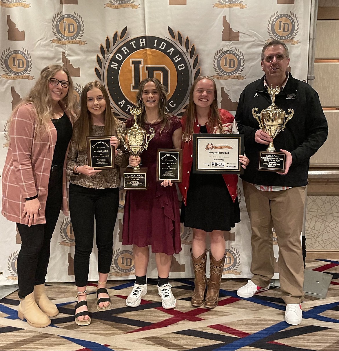 Sandpoint High School's Taylor Mire (second from left), Aliya Strock (middle), and William Love (right), pose with their awards from the North Idaho HOF Awards Ceremony.