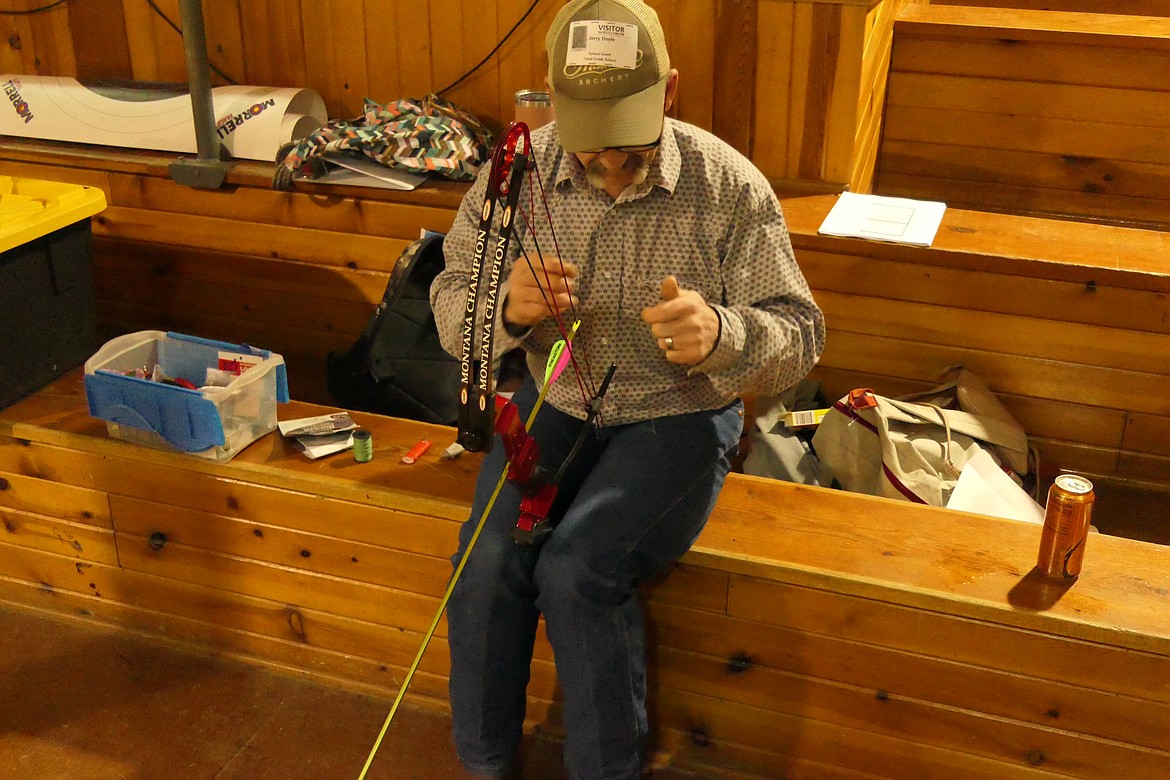 Long time archery coach Jerry Doyle works on archery equipment during a practice last week as the Trout Creek middle school team prepares for the National championships at the end of April in Sandy, Utah.  (Chuck Bandel/VP-MI)