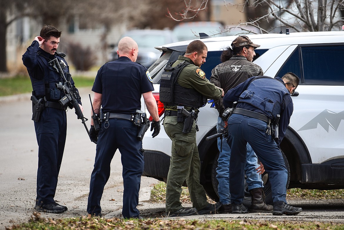 Law enforcement personnel take a suspect into custody after an assault with a weapon call turned into an armed standoff between Second and Third Avenue West North in Kalispell on Tuesday, April 11. (Casey Kreider/Daily Inter Lake)