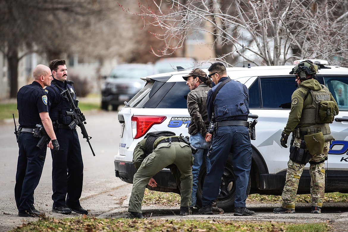 Law enforcement personnel take a suspect into custody after an assault with a weapon call turned into an armed standoff between Second and Third Avenue West North in Kalispell on Tuesday, April 11. (Casey Kreider/Daily Inter Lake)