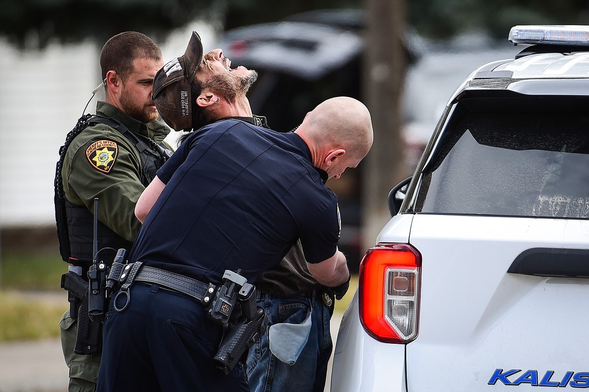 A suspect yells after he is taken into custody during an armed standoff between Second and Third Avenue West North in Kalispell on Tuesday, April 11. (Casey Kreider/Daily Inter Lake)