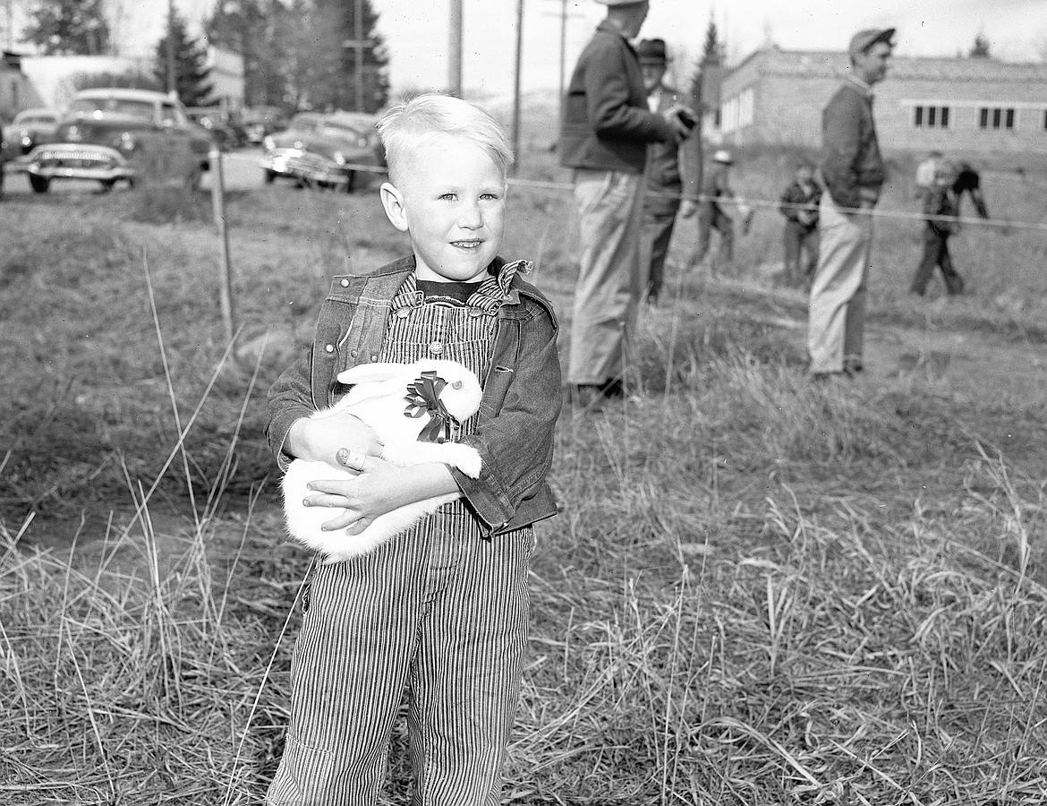 Youngster Brian Kelly won a live rabbit — one of the prizes of the April 4, 1953 hunt. The Lions Club put out more than 900 eggs at what appears today to be Pinewood Park on Fourth Avenue West. (Mel Ruder photo)