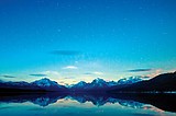 Light at lake is out, stars shine bright in Glacier Park