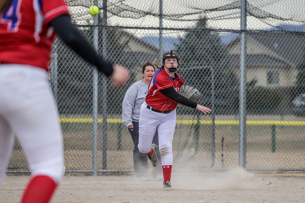 Haden Peters throws for an out at first at Glacier High School on Friday against the Wolfpack. (JP Edge photo)