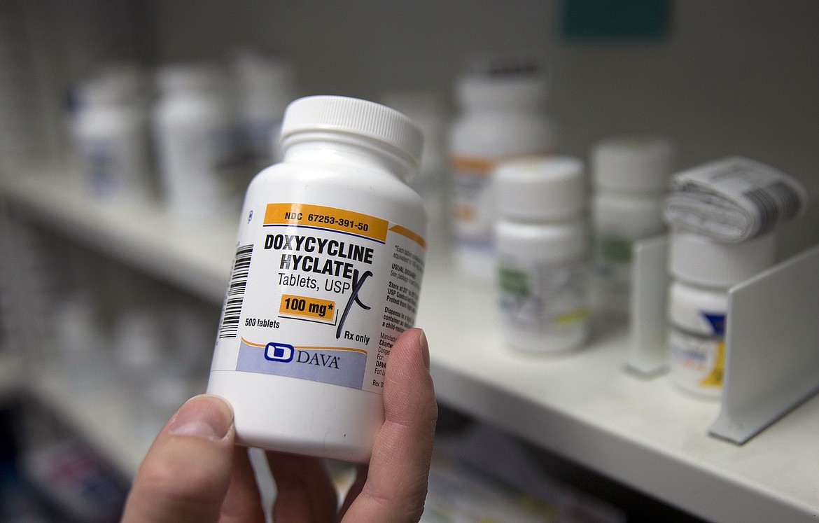 A pharmacist holds a bottle of the antibiotic doxycycline hyclate in Sacramento, Calif., July 8, 2016. On Tuesday, April 11, 2023, the Centers for Disease Control and Prevention released data about some of the most common infectious diseases in the U.S. The numbers show how chlamydia, gonorrhea and syphilis infections have been accelerating across the country. Meanwhile, the CDC is considering recommending the antibiotic doxycycline to be used after sex to prevent those infections. (AP Photo/Rich Pedroncelli, File)