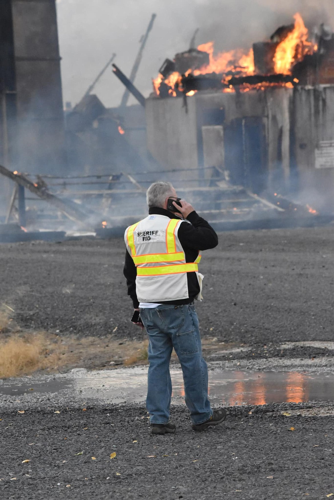 Kyle Foreman, public information officer for the Grant County Sheriff’s Office, talks on the phone during the fire at the Wilbur-Ellis fertilizer plant in October. Fires, car accidents, crime scenes and a wide variety of other incidents all see Foreman out working to gather information and get it to the community to keep Grant County residents safe during emergencies.