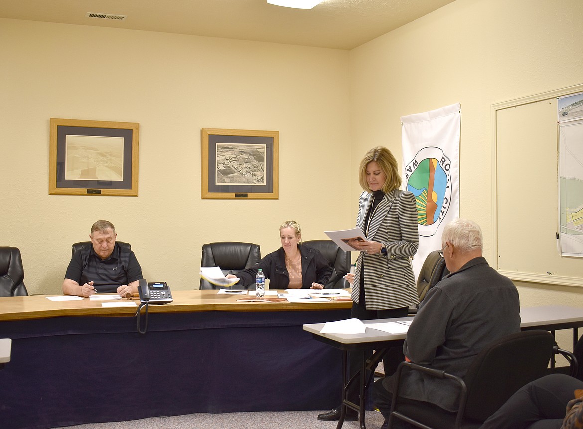 Grant County Commissioner Cindy Carter, standing, addresses Royal City Mayor Kent Anderson, left, Council Members Mackenzee Anderson, right, and Tiffany Workinger, behind Carter, and City Public Works Director John Lasen at the city council meeting Tuesday. Council Members Perla Garcia and Michael Christensen attended the meeting by phone.