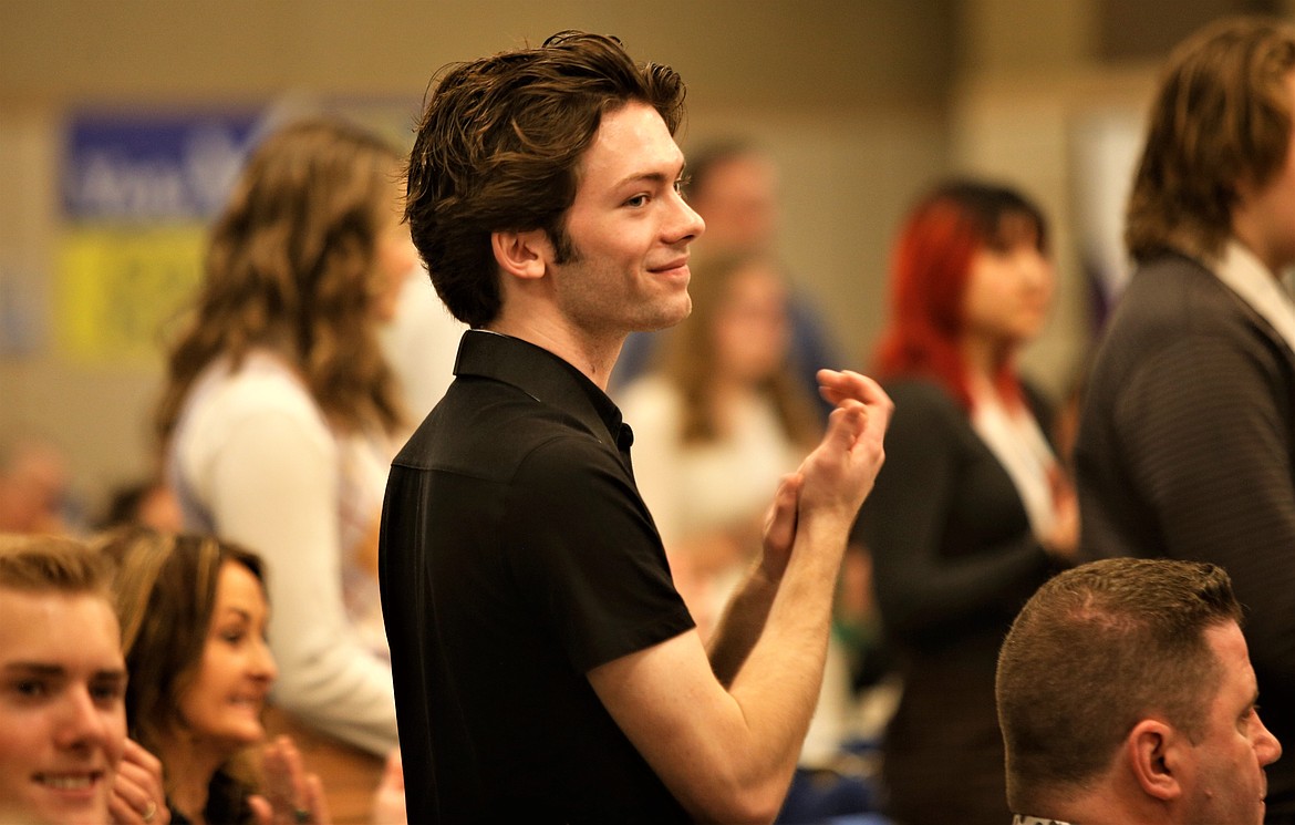 Bobby Dorame, Coeur d'Alene High School senior, applauds during the Coeur d'Alene Regional Chamber's scholarship awards program on Tuesday at The Coeur d'Alene Resort.