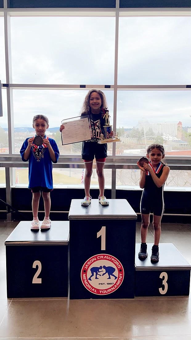 Isabella Mendez, center, smiles atop the podium after capturing a first-place finish at the Jason Crawford Memorial Tournament in Spokane last week.