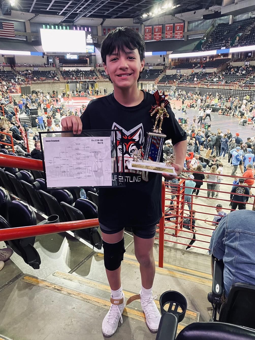 Xavier Mendez smiles with his first-place trophy after leaving the Jason Crawford Memorial Tournament with a title in the boys age 11 and 12 98-100-pound division.
