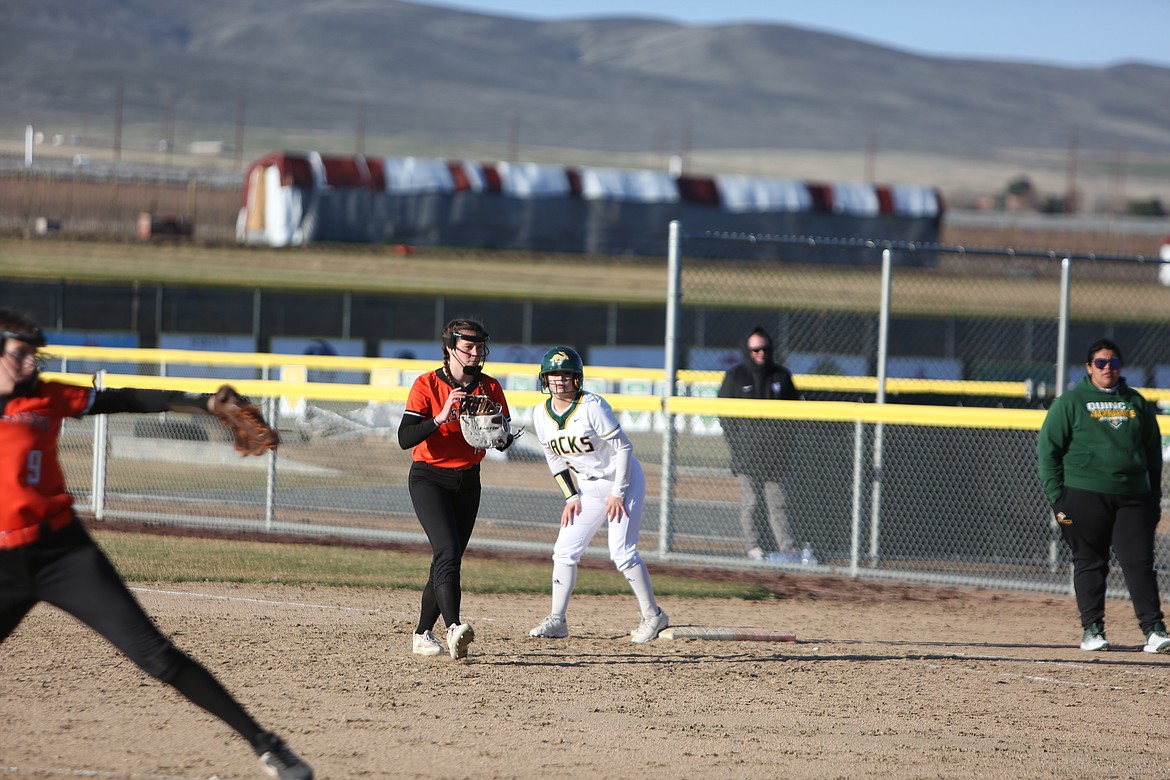 Quincy sophomore Amy Buenrostro, in white, waits on first base during the bottom of the sixth inning against Cashmere.