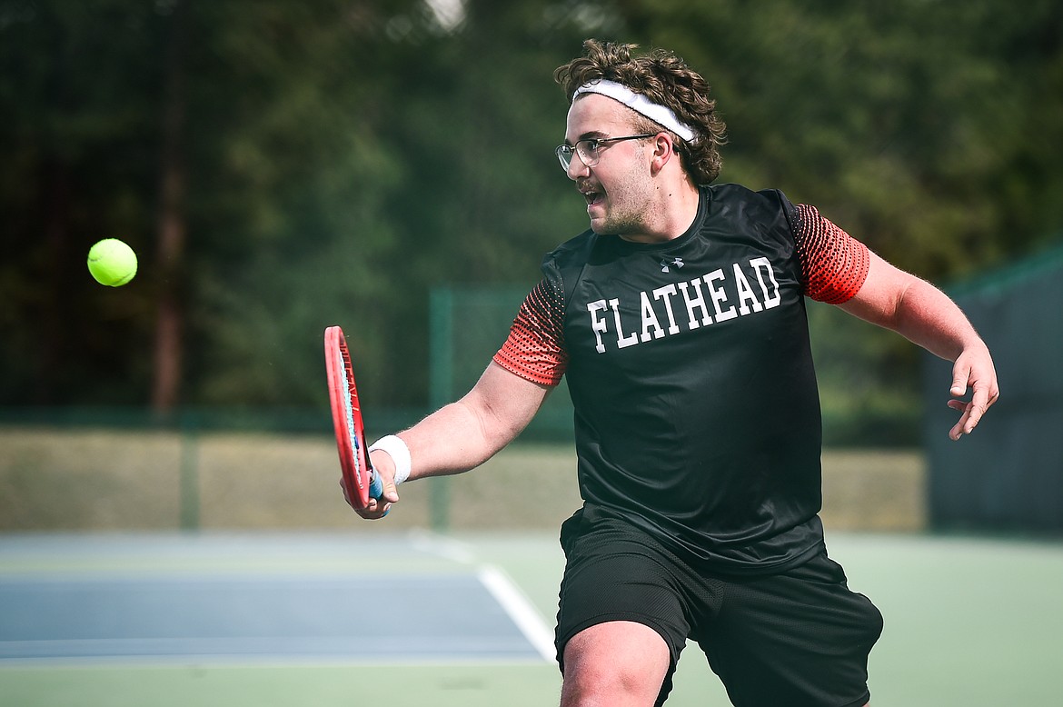 Flathead's Quaid Ring hits a return against Glacier's Will Rudbach in a boys singles match at Flathead Valley Community College on Thursday, April 13. (Casey Kreider/Daily Inter Lake)