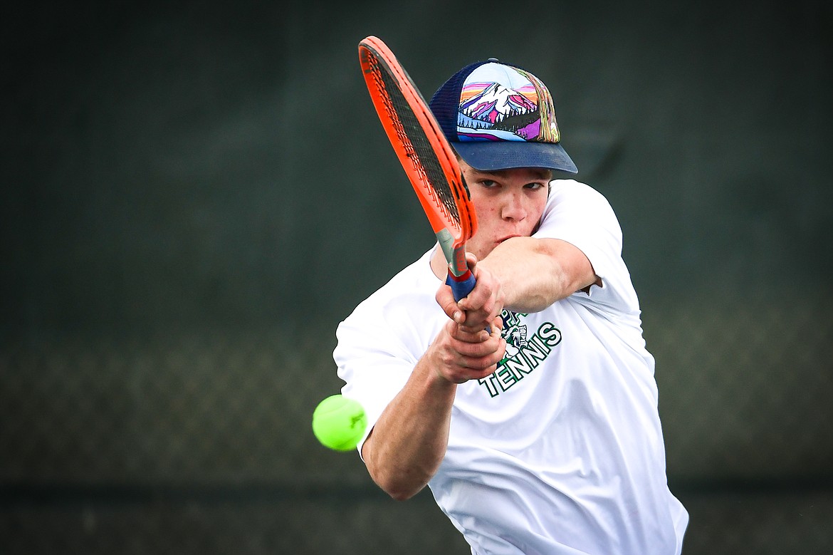 Glacier's Kutuk White hits a return in a boys singles match against Flathead's Kobe Schlegel at Flathead Valley Community College on Thursday, April 13. (Casey Kreider/Daily Inter Lake)