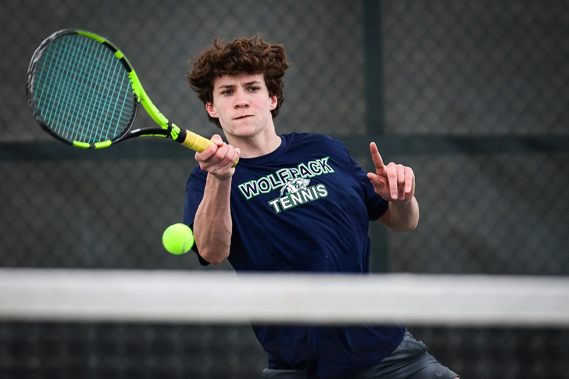 Glacier's Will Rudbach hits a return against Flathead's Quaid Ring in a boys singles match at Flathead Valley Community College on Thursday, April 13. (Casey Kreider/Daily Inter Lake)