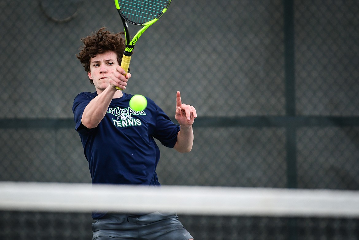 Glacier's Will Rudbach hits a return against Flathead's Quaid Ring in a boys singles match at Flathead Valley Community College on Thursday, April 13. (Casey Kreider/Daily Inter Lake)