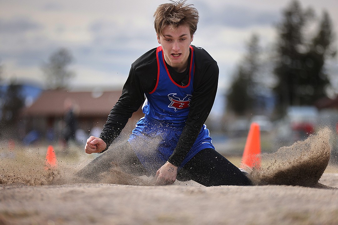 Levi Peterson competes in the long jump