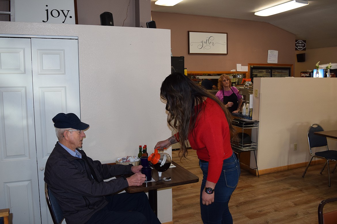 Gabriela Dircio warms up a customer’s coffee at Country Deli in Ephrata Thursday morning. Sticking to the solid breakfast menu the restaurant already has is important to taking care of the community, she said.