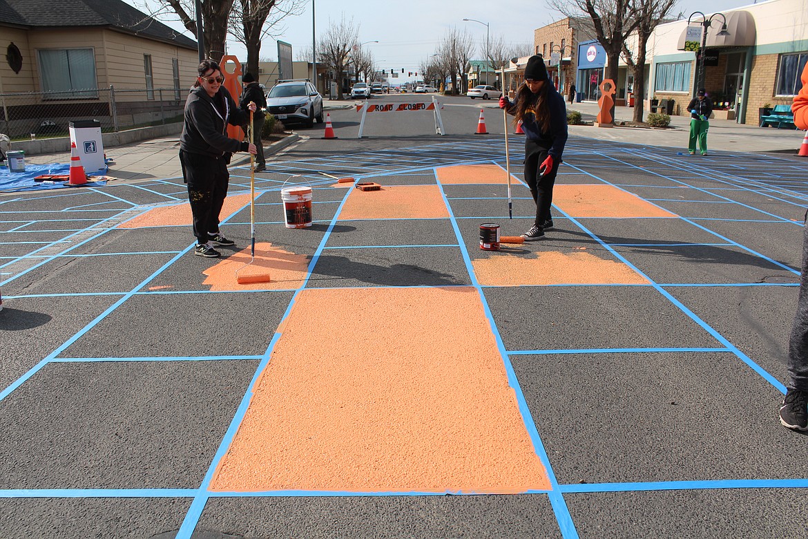 Krista Nightengale, left and Marissa Lopez, right, of the Better Block Foundation take to the streets of Quincy to paint.