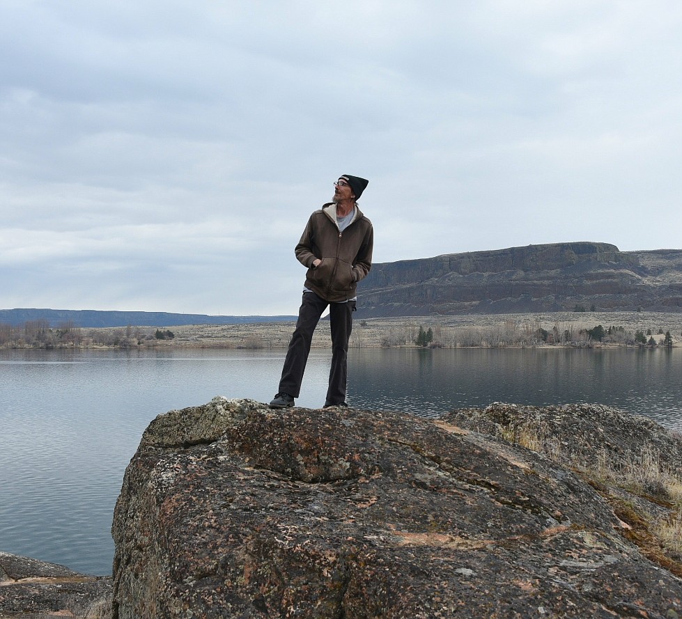 John Kemble stands on a rock with Banks Lake in the background. Kemble recently released a book focused on the history of the lake and its surroundings. He urges locals to read the book to learn more about the history of the area they live in.