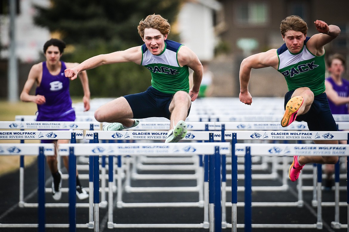 Glacier's Ethan Anderson, center, and Evan Barnes, right, took first and second in the 110 meter hurdles during a dual track meet with Butte at Glacier High School on Friday, April 14. (Casey Kreider/Daily Inter Lake)