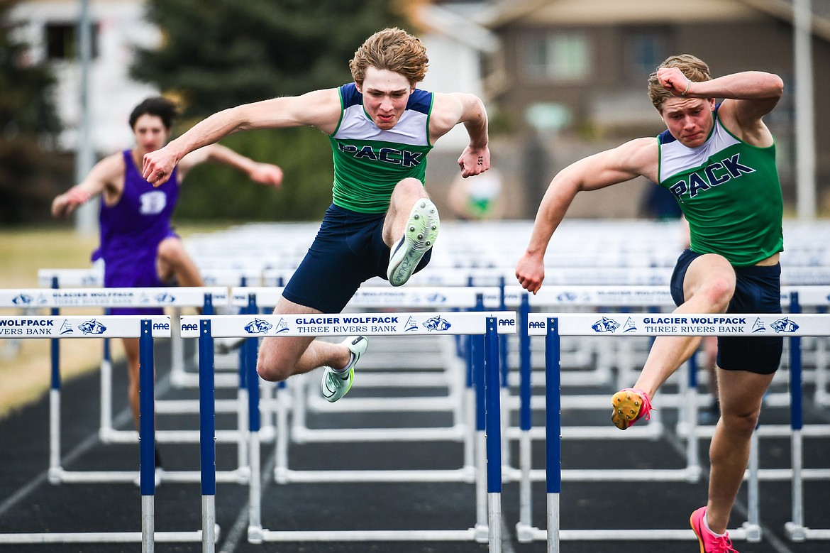 Glacier's Ethan Anderson, center, and Evan Barnes, right, took first and second in the 110 meter hurdles during a dual track meet with Butte at Glacier High School on Friday, April 14. (Casey Kreider/Daily Inter Lake)