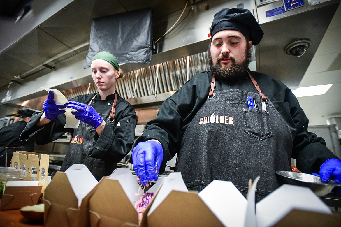 Chefs Mackinzie Wilson, left, and Mike Bruner fill orders at Flathead Valley Community College's pop-up lunch restaurant "Smolder," operated by students in the school's Culinary Institute of Montana on Thursday, April 13. (Casey Kreider/Daily Inter Lake)