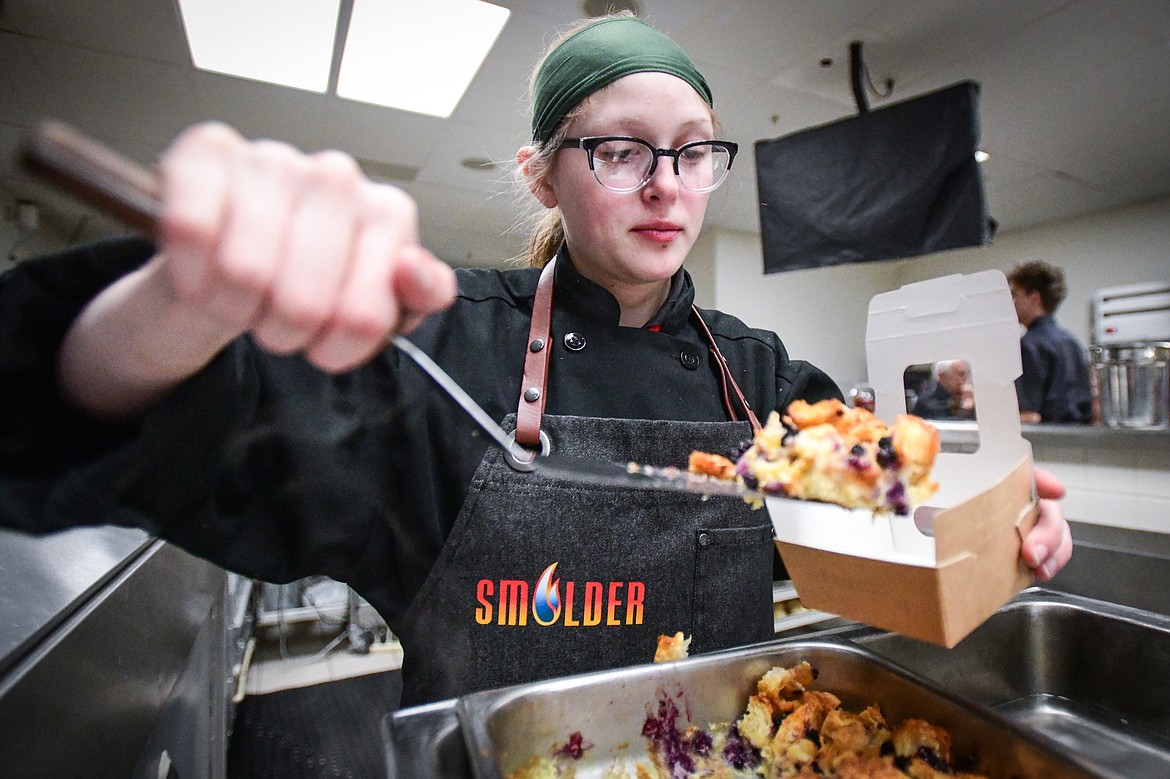 Chef Julieanna Byrd fills a container with Huckleberry Bread Pudding for a customer at Flathead Valley Community College's pop-up lunch restaurant "Smolder," operated by students in the school's Culinary Institute of Montana on Thursday, April 13. (Casey Kreider/Daily Inter Lake)