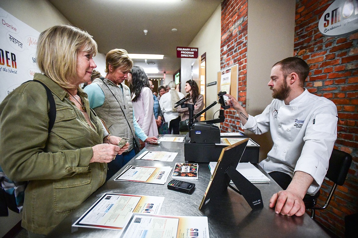 Chef Dan Moe, Baking & Pastry Instructor at Flathead Valley Community College's Culinary Institute of Montana, takes food orders from a line of customers at the school's pop-up lunch restaurant "Smolder"  on Thursday, April 13. (Casey Kreider/Daily Inter Lake)