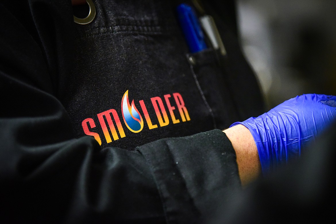 The 'Smolder' logo on chef Mike Bruner's jacket at Flathead Valley Community College's pop-up lunch restaurant operated by students in the school's Culinary Institute of Montana on Thursday, April 13. (Casey Kreider/Daily Inter Lake)