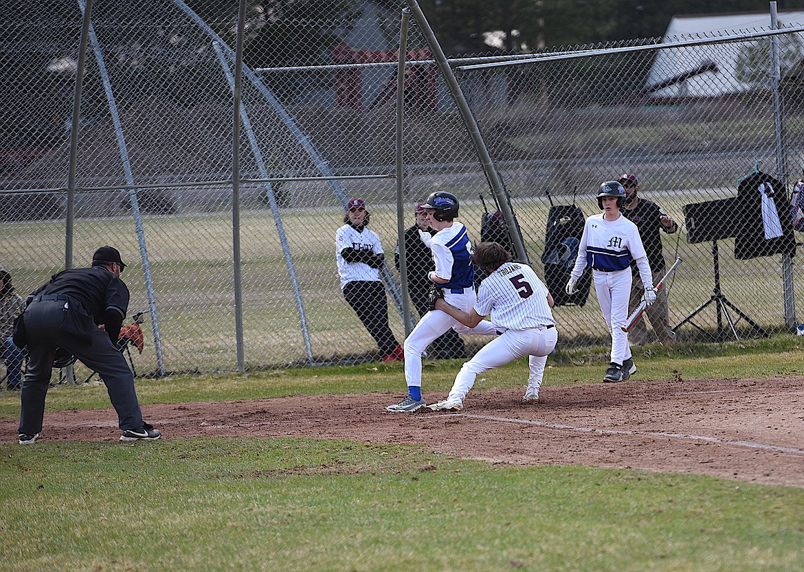 Troy starting pitcher Paxton Fisher tags a Mission player in a play at the plate on Thursday, April 13, 2023. (Scott Shindledecker/The Western News)