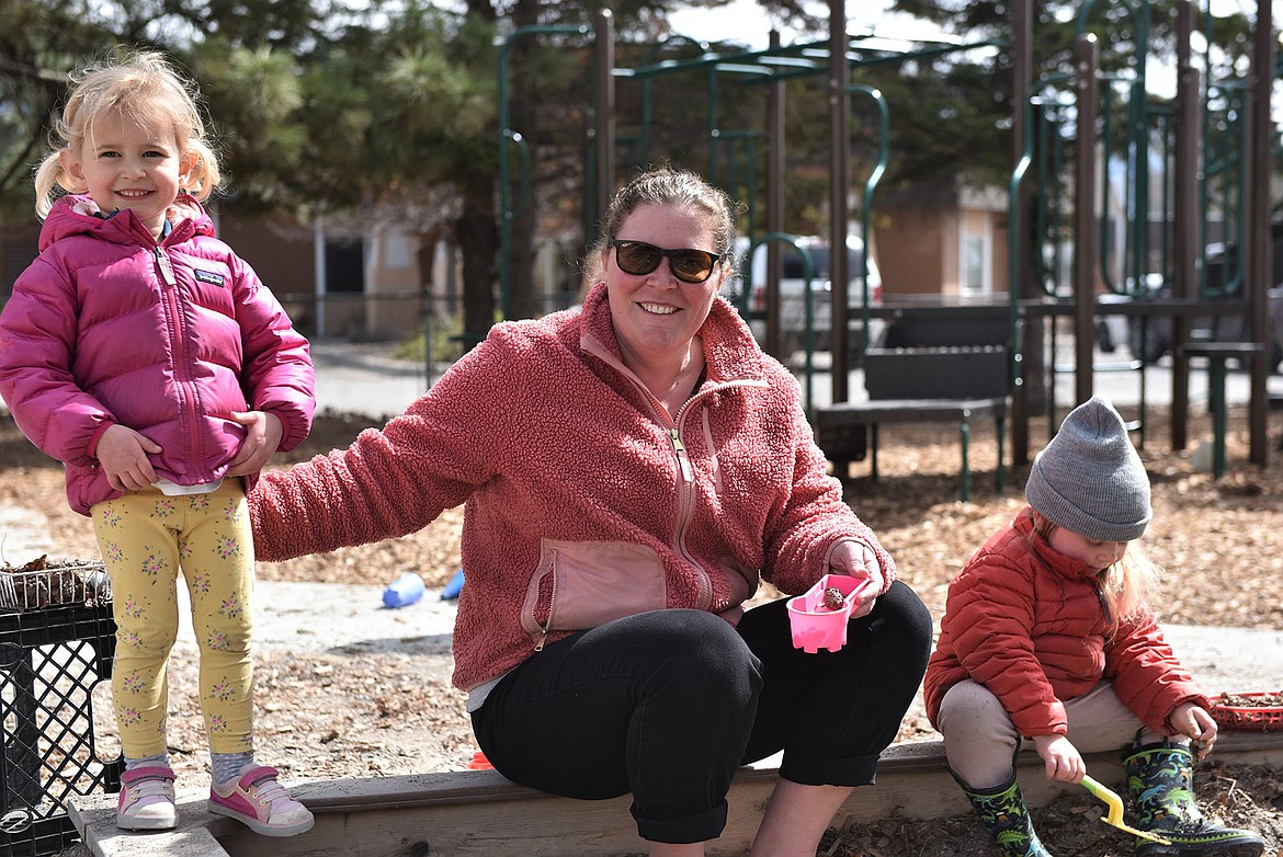 Carrie Lamb, Executive Director of Children's House Montessori School, enjoys the sunshine at the sandbox. (Julie Engler/Whitefish Pilot)