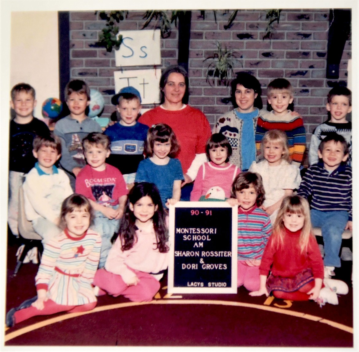 The current executive director of the Children's House Montessori School is seen in this photo of the class of 1990-91. Carrie Lamb is in the front row, holding the right side of the sign. (Photo provided)