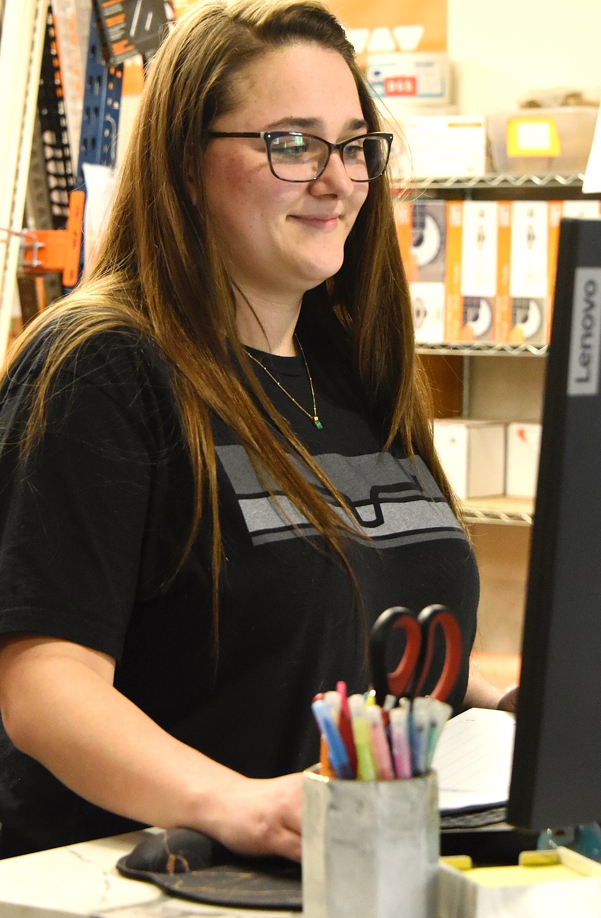 Miranda Jensen, who works in the Home Floor Covering warehouse, enters an order. (Berl Tiskus/Leader)
