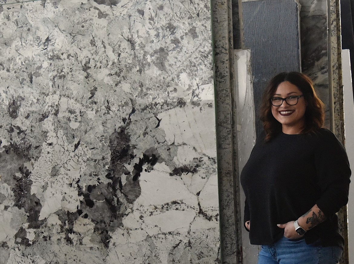 Home Flooring Covering Sales Staffer Alyssa Vargas stands by a favorite piece of granite in the slab yard. (Berl Tiskus/Leader)