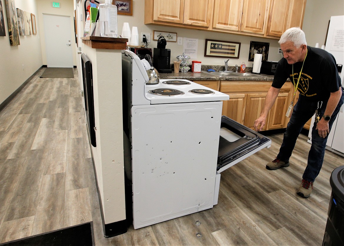 Bob Smith opens the door of the oven in the training center building at the Fernan Rod and Gun Club on Friday. The oven was struck with several bullets in a Feb. 25 shooting.