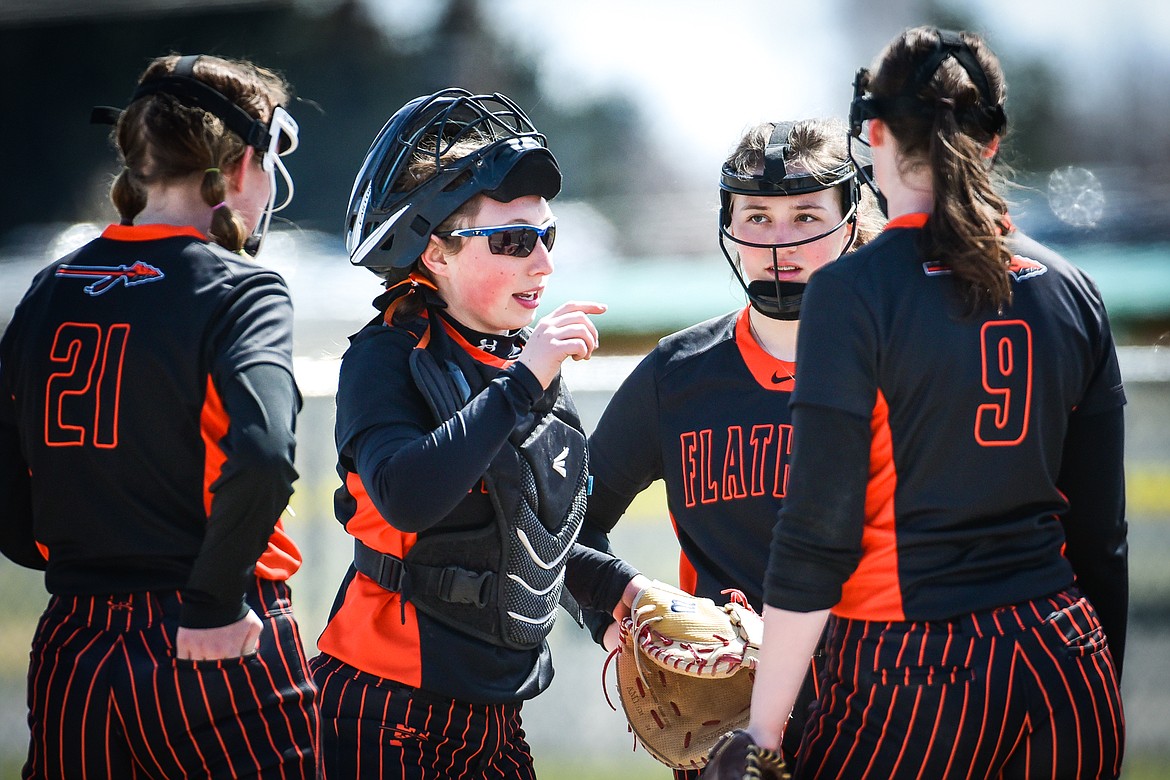 Flathead catcher Laynee Vessar (12) talks to the infield during a meeting on the mound against Helena on Saturday, April 15. (Casey Kreider/Daily Inter Lake)