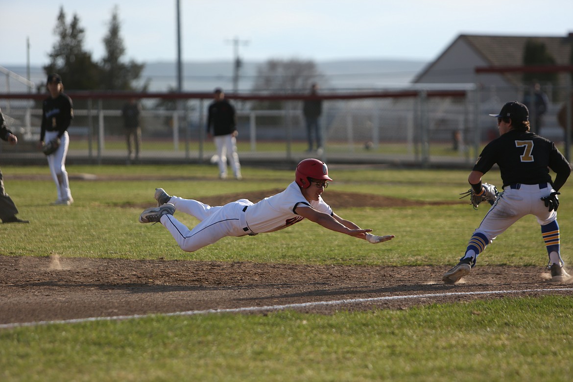 Othello senior Eliez Gutierrez dives toward third base during the bottom of the fifth inning in Thursday’s game against Hazen. Gutierrez later stole home off a wild pitch in the same inning.