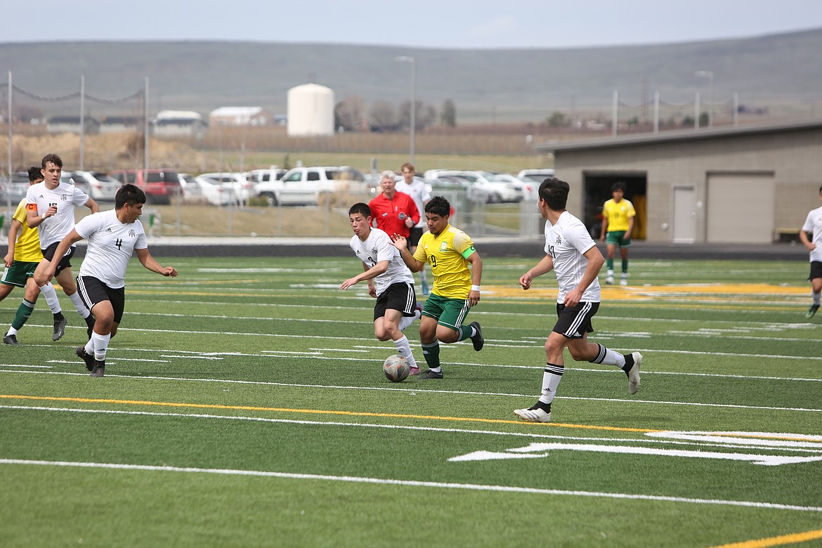 Quincy senior Jorge Nunez works his way through the Royal defense during the first half of Saturday’s non-league matchup against the Knights. Nunez scored a goal in the second half.