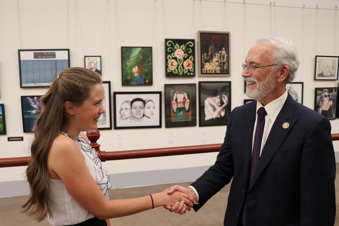 Regional first-place winner of the 2019 Congressional Art Competition Meredith Sconce of Almira/Coulee-Hartline High School, left, shakes hands with Rep. Dan Newhouse. Entries for this year's competition are due by April 25.