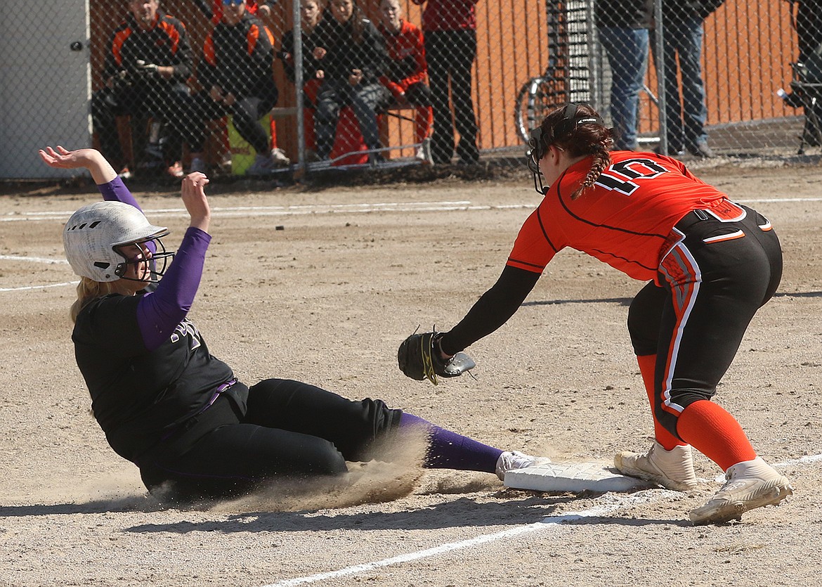 Avery Starr is safe as third baseman Morgan Simpson reaches for the out in last week's Polson-Ronan softball game. (Bob Gunderson photo)