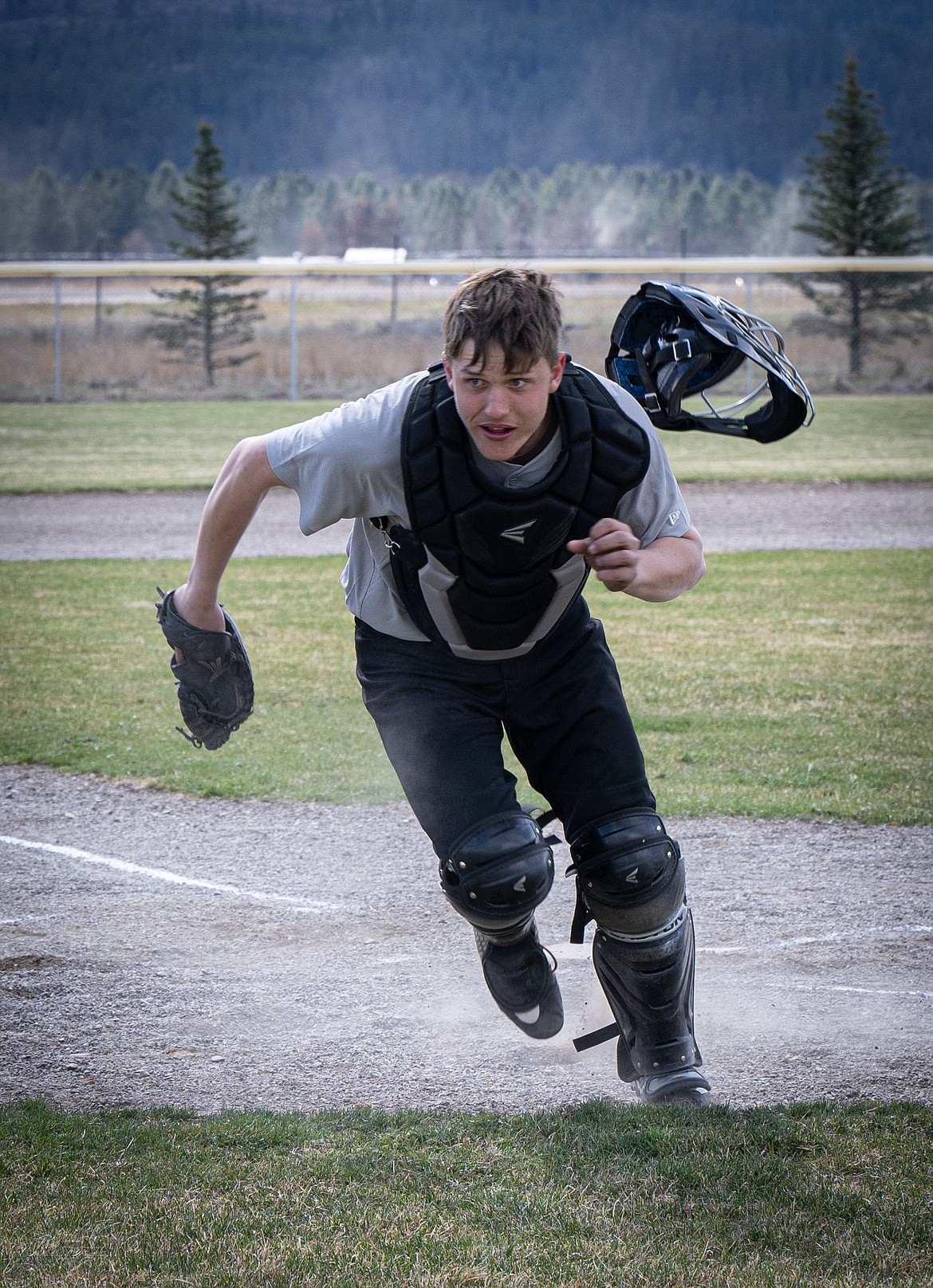 Savage Horsemen catcher Garth Parker sheds his mask and chases after a wild pitch during Plains' game last week against Browning. (Tracy Scott/Valley Press)