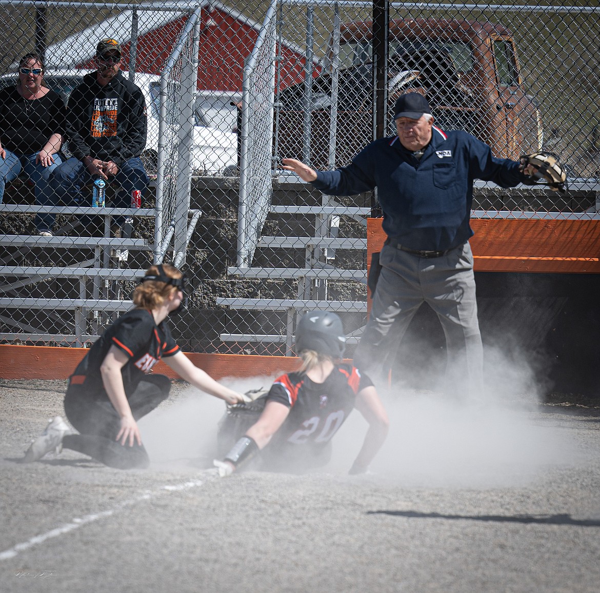 Plains sophomore Maddy Blood kicks up a cloud of dust as she slides safely into home during Saturday's game with Eureka at the Plains High field.  (Tracy Scott/Valley Press)