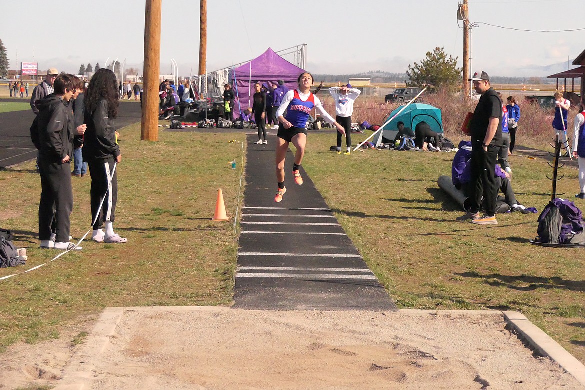 Superior's Isabella Pereira goes airborne during the triple jump event at Saturday's Dilly Bar Invitational in Ronan.  Pereira finished second in the event and won the 100 meters for the Lady Cats.  (Chuck Bandel/VP-MI)