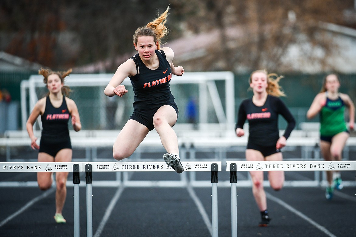 Flathead's Zoey Bortz clears a hurdle en route to a first place finish in the 300 hurdles during a crosstown track meet with Glacier at Legends Stadium on Tuesday, April 18. (Casey Kreider/Daily Inter Lake)