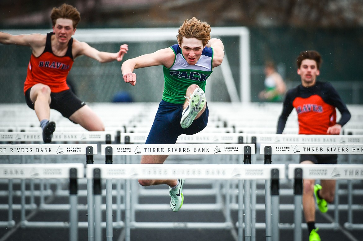 Glacier's Ethan Anderson clears a hurdle en route to a first place finish in the 110 meter hurdles during a crosstown track meet with Flathead at Legends Stadium on Tuesday, April 18. (Casey Kreider/Daily Inter Lake)